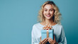 Young woman, girl on a blue background holding a big gift box holiday surprise, compliment, generated by AI