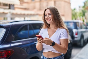 Sticker - Young blonde woman smiling confident using smartphone at street