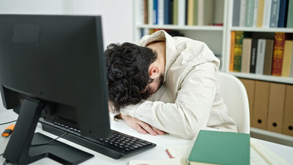 Poster - Young hispanic man student stressed using computer studying at library university