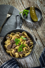 Canvas Print - Italian pasta shells with beef sauce in cast iron pan.