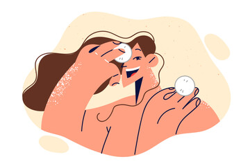 Wall Mural - Woman uses cotton pads to treat face and fight wrinkles or remove excess makeup before bed.