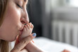 © puhimec - Caring young mother kissing baby's feet, copy space.