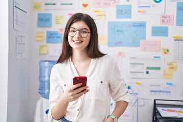 Sticker - Young caucasian woman business worker using smartphone working at office