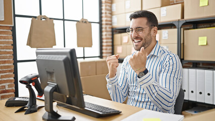 Sticker - Young hispanic man ecommerce business worker using computer with winner expression at office