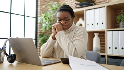 Canvas Print - African american woman business worker reading document using laptop at office