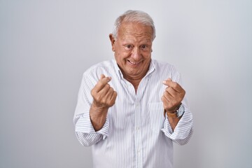 Sticker - Senior man with grey hair standing over isolated background doing money gesture with hands, asking for salary payment, millionaire business