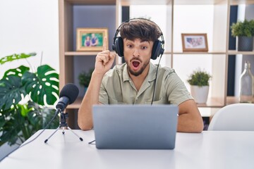 Poster - Arab man with beard working at the radio pointing finger up with successful idea. exited and happy. number one.