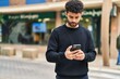 © Krakenimages.com - Young arab man using smartphone at street