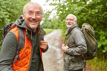 Wall Mural - Elderly man with male friend in background at forest