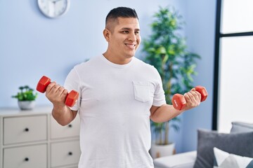 Poster - Young latin man smiling confident using dumbbells training at home