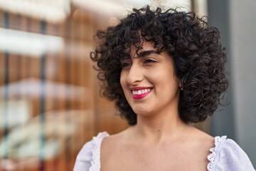 Sticker - Young middle east woman smiling confident looking to the side at street