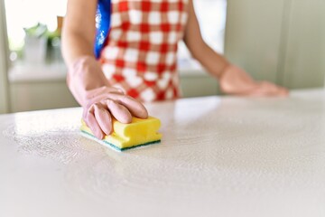 Sticker - Young woman cleaning table at kitchen