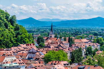 Wall Mural - A view over the rooftops towards buildings at the foot of the castle hill in Ljubljana, Slovenia in summertime