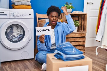 Sticker - African american woman donating clothes annoyed and frustrated shouting with anger, yelling crazy with anger and hand raised