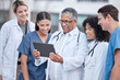 Leinwandbild Motiv Tablet, doctors and healthcare people at hospital outdoor with clinic management, research and online teamwork. Group, telehealth and medical staff, nurses and mentor with digital technology training