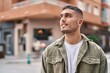 © Krakenimages.com - Young hispanic man smiling confident standing at street