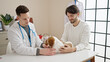 © Krakenimages.com - Two men petting dog at veterinary clinic