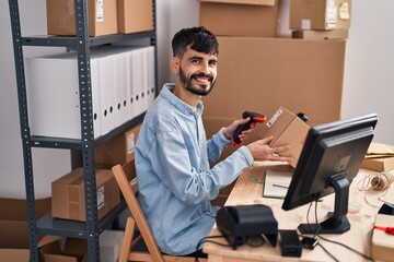 Sticker - Young hispanic man ecommerce business worker scanning package at office