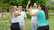 © Krakenimages.com - Group of people wearing sportswear high five with hands at park