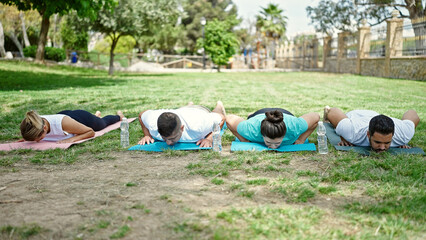 Poster - Group of people training yoga lying on mat at park