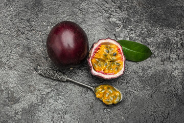 Wall Mural - Passion fruit Maracuya cut in half slice on a dark background, Long banner format. top view