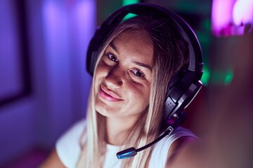 Poster - Young beautiful hispanic woman streamer smiling confident making selfie by camera at gaming room