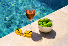 Glass Of Pink Wine And Yellow Sunglasses At The Pool.