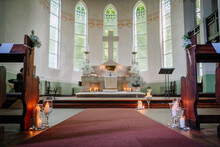 The Interior Of The Church Is Adorned With Beautiful Stained Glass Windows, Ornate Wooden Pews, And A Magnificent Altar