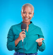 Woman, microphone and studio portrait for interview, news program or questions for talk show by blue background. Young African reporter, journalist or happy tv host with holding mic, speech and press