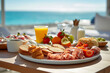 canvas print picture - Frühstück im Urlaub unter freiem Himmel mit Blick auf das Meer im Sonnenschein.