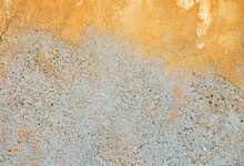 Background Of Old Plaster With Remnants Of Ocher Color Paint