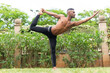 © ADDICTIVE STOCK - Black calm man doing yoga in Dancer Pose