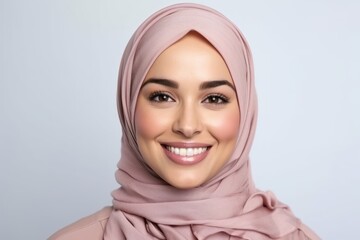 Portrait of beautiful young muslim woman wearing hijab smiling at camera