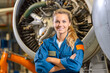 © MVProductions - Proud and confident female aerospace engineer working on an aircraft or spacecraft part. Generative AI