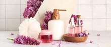 Bottle Of Liquid Soap With Serum, Cosmetic Gel, Bast Wisp And Lilac Flowers On Light Background