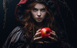 A good looking young woman witch offers a poisoned red apple