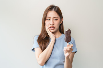 Face expression suffering from sensitive teeth, Asian young woman touching cheek