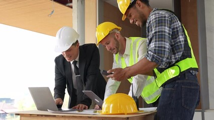 Wall Mural - Architect team working with blueprints for architectural plan, engineer sketching a construction project, green energy concept