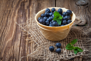 Wall Mural - Blackberries, raspberries and blueberries in a waffle bowls.