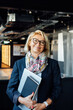 © okrasiuk - Portrait of smiling 50's stylish, confident mature businesswoman, middle aged company ceo director, experienced senior female professional, business coach team leader in modern office. Female leader