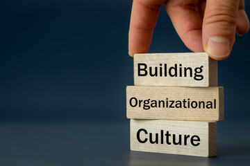 A wooden block with the words Building, Organizational, Culture, Modern approach to working with people in a team, Creative concept, copy space