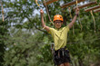 © Daniel CHETRONI - Boy enjoys climbing in the ropes course adventure. Happy boys playing at adventure park holding ropes and climbing wooden stairs