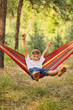 © Inna Vlasova - Cute little blond caucasian boy having fun with multicolored hammock