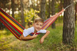 © Inna Vlasova - Cute little blond caucasian boy having fun with multicolored hammock