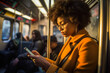 © MVProductions - Morning shot of african american woman using her smartphone during her subway commute, engrossed in work and connectivity, generative ai