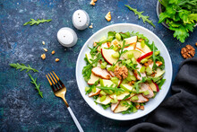 Waldorf Salad With Fresh Apple, Celery, Lettuce, Grilled Chicken Fillet, Arugula And Walnuts On Plate, Blue Table Background, Top View