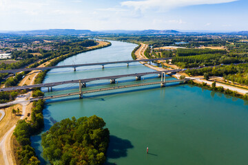 Panoramic view of suspension bridge Pont de Roquemaure, highway bridge and railway Viaduc de Roquemaure across Rhone river, France