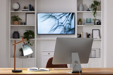 Poster - Cosy workplace with computer near tv area. Interior design