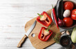 © New Africa - Cooking delicious ratatouille. Fresh ripe vegetables, knife and bowl on white wooden table, flat lay. Space for text