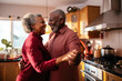 © MVProductions - Authentic moment of an African American retired couple sharing a dance in the kitchen, an embodiment of enduring love and romance, generative ai